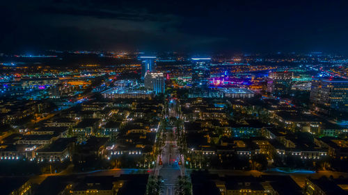 High angle view of illuminated cityscape against sky at night