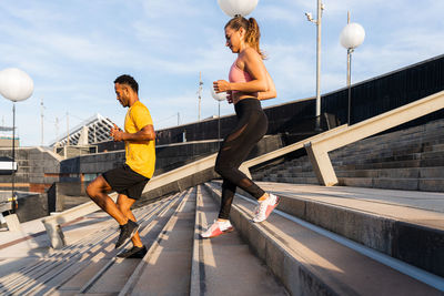 Side view of young woman exercising in gym