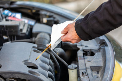 Cropped hands of man working on car