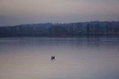 Scenic view of lake against sky during sunset