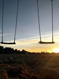 Silhouette of electricity pylon against sky