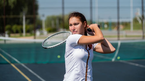 Tennis player holding racket at court