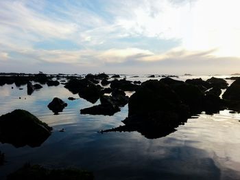 Rock formation in sea against sky