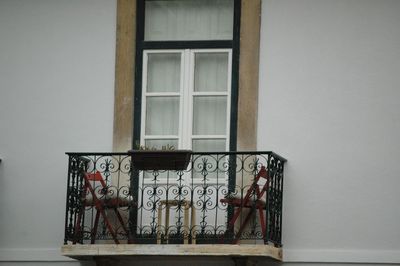 Chairs and stool on building balcony