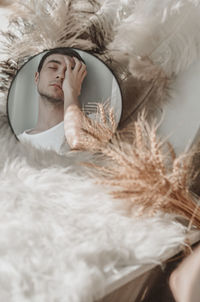 Portrait of young man lying on bed at home