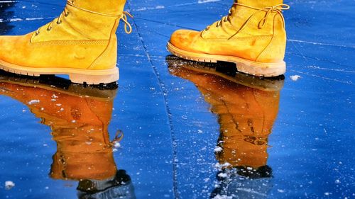 Low section of man standing on ice