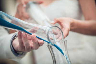 Close-up of hands pouring liquid