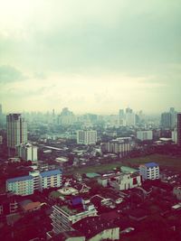 Cityscape against cloudy sky