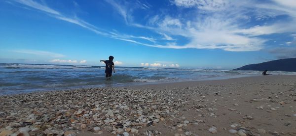 Man on beach against sky