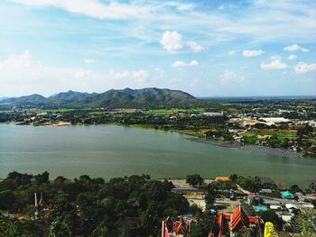 High angle view of city by sea against sky