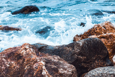 Waves splashing on rocks at shore