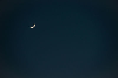 Low angle view of moon against sky at night