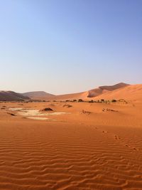 Scenic view of desert against clear blue sky