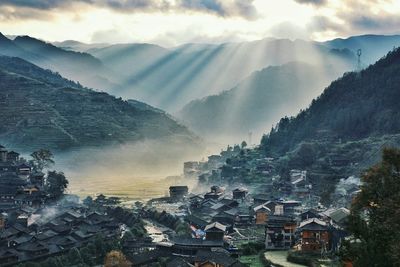 Sunlight falling on residential district by mountain