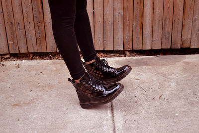 Low section of woman balancing on shoe soul