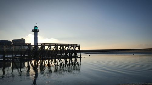 Pier over sea against clear sky