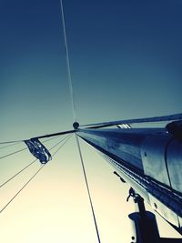 Low angle view of tall against clear blue sky