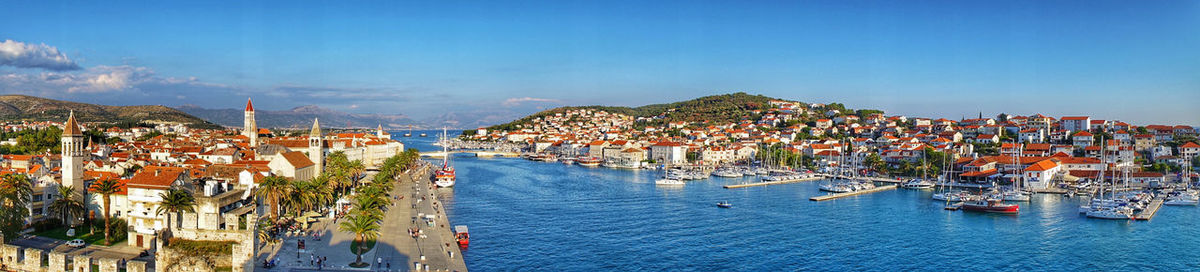 High angle view of townscape by sea against sky