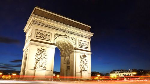 Light trails by arc de triomphe at night