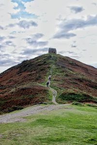 Man standing on mountain against sky