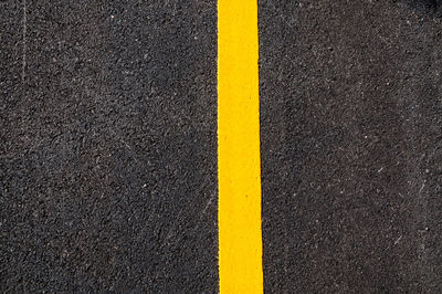 High angle view of yellow sign on road