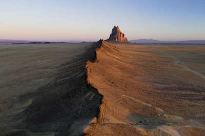 Aerial with leading line of lava towards shiprock in new mexico