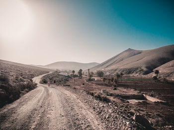 Panoramic view of road on desert against clear sky