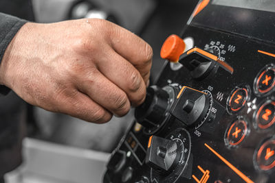 Close-up of man working on escalator