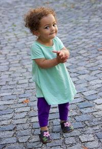 Portrait of cute girl standing on road