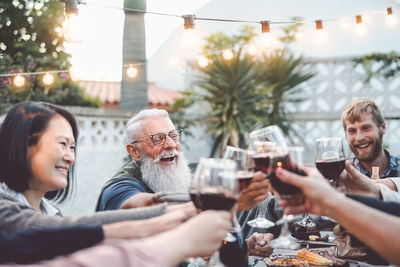 People toasting glasses on table