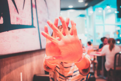 Woman covering face in restaurant