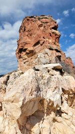 Low angle view of rock formations against sky