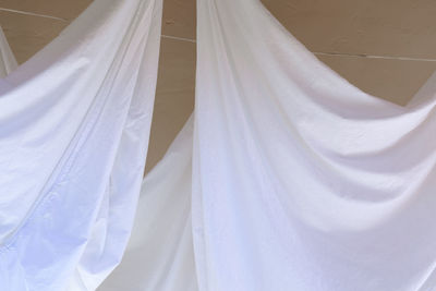 White curtains hanging from ceiling