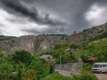 Houses against cloudy sky