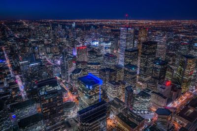 High angle view of city lit up at night