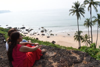 Woman looking at sea against sky