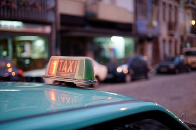 Signboard with text on taxi in city