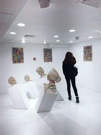 Rear view of woman standing in shopping mall