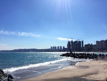 View of sea with cityscape in background
