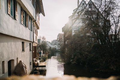 Canal amidst buildings against sky