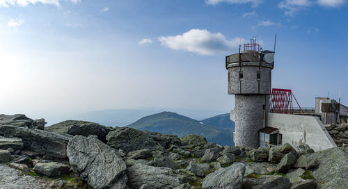 Tower by building against sky