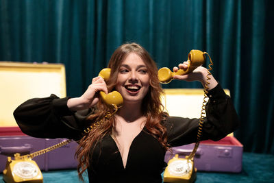 Portrait of young woman drinking juice at home