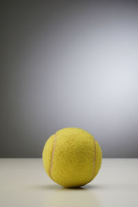 Close-up of yellow ball on table