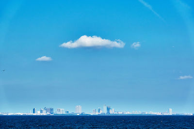 Scenic view of sea and buildings against sky