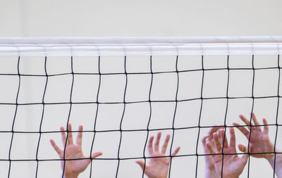 Cropped hands playing volleyball