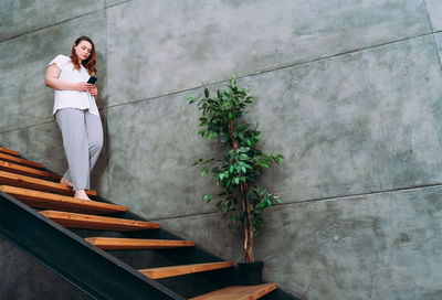 Woman standing against wall