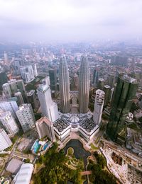 High angle view of modern buildings in city against sky