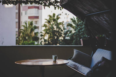 Coffee cup on table against building