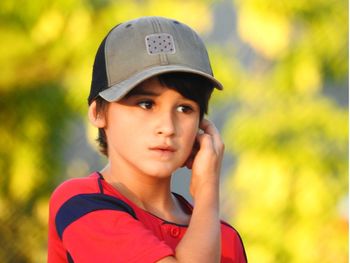 Boy wearing cap looking away 