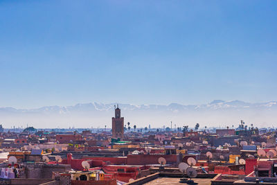 High angle view of buildings against blue sky